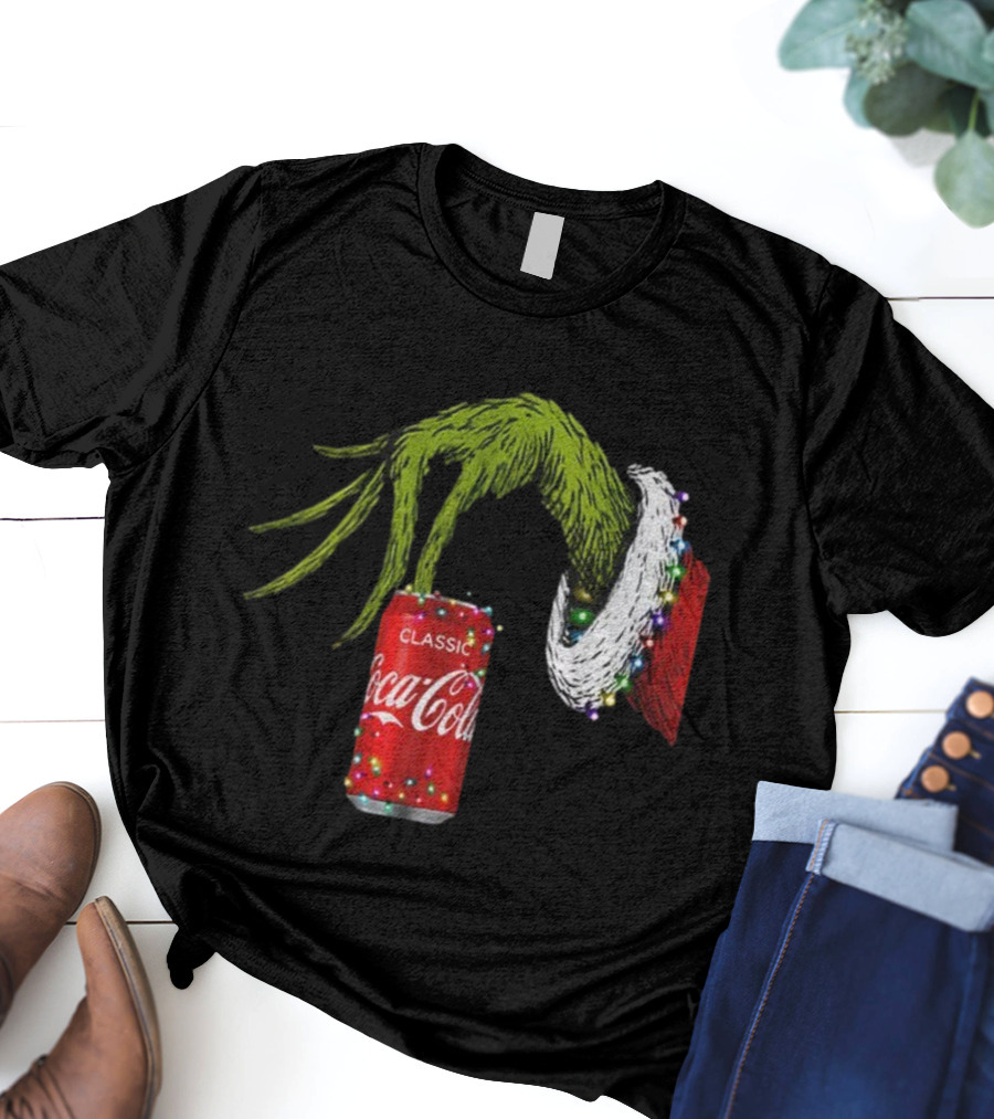 Grinch Hand Holding Coca-Cola Can Wrapped In Christmas Lights Merry Christmas T-Shirt