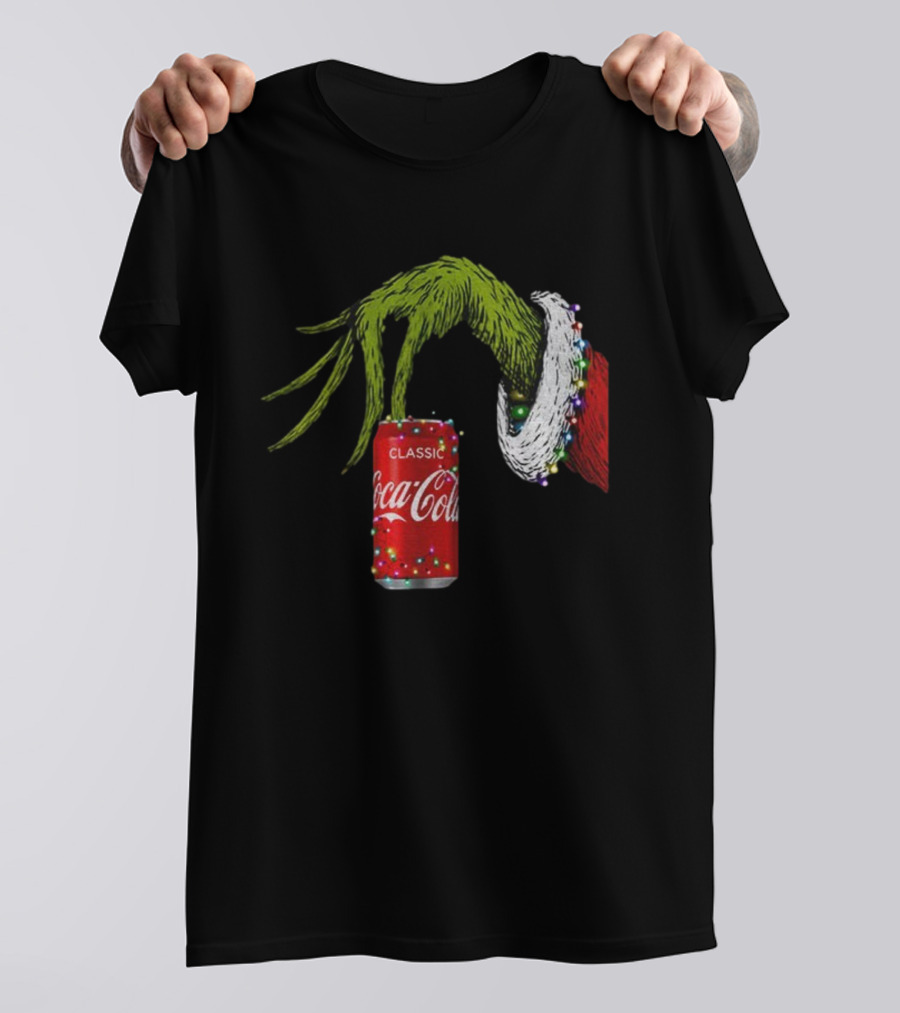Grinch Hand Holding Coca-Cola Can Wrapped In Christmas Lights Merry Christmas T-Shirt