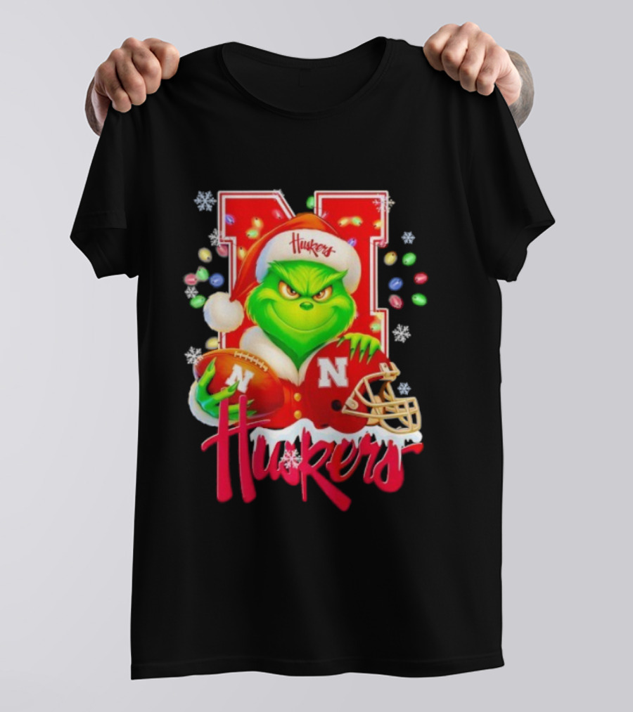 Grinch Santa With Nebraska Cornhuskers Helmet And Football Merry Christmas Huskers T-Shirt