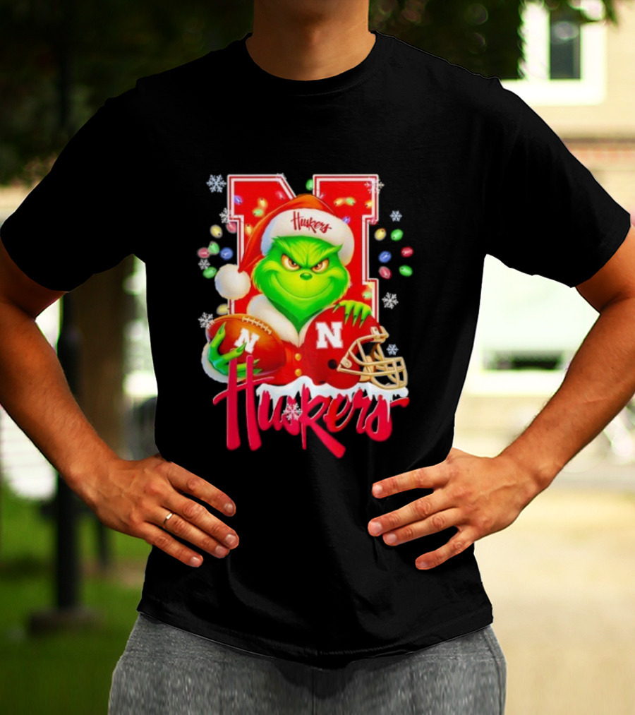 Grinch Santa With Nebraska Cornhuskers Helmet And Football Merry Christmas Huskers T-Shirt