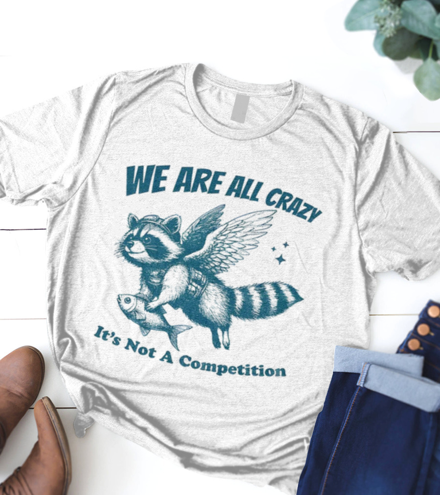 Raccoon With Wings Holding Fish We Are All Crazy It's Not A Competition T-Shirt