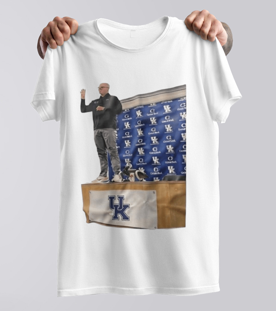 UK Volleyball Coach Craig Skinner Standing On Table With UK Logo And Awards T-Shirt