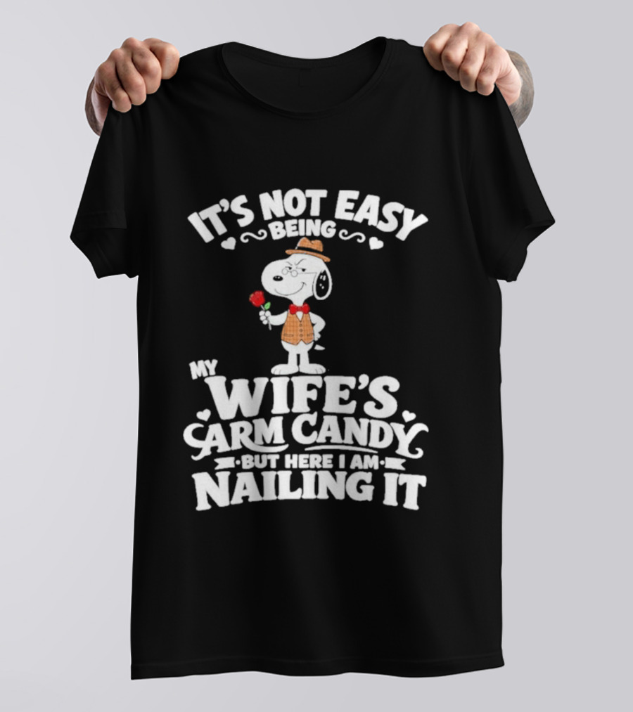 Snoopy It's Not Easy Being My Wife's Arm Candy But Here I Am Nailing It T-Shirt