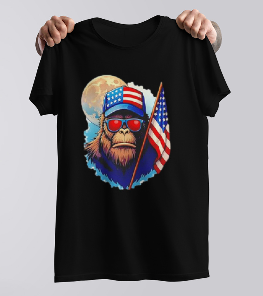 Bigfoot USA Flag Hat Sunglasses Patriotic Moon Background T-Shirt